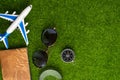 Background for travel and vacation. Weekend, summer mood. Airplane, passport, compass. Green grass for background