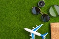 Background for travel and vacation. Weekend, summer mood. Airplane, passport, compass. Green grass for background