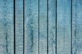 The background is turquoise and the color of old painted wooden boards. Wooden background blue with peeling paint from long boards Royalty Free Stock Photo