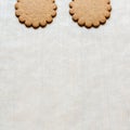 Background with two ginger cookies on baking paper, traditional Christmas treat. Text space, empty template Royalty Free Stock Photo