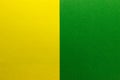 Background of two vertical rectangles yellow and green. Sheets of blank yellow and green paper with fine texture, split vertically Royalty Free Stock Photo