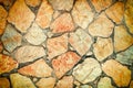 Background of uneven large stones. Mosaic of red and orange cobblestones. Beautiful background with stone texture. Royalty Free Stock Photo