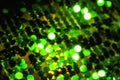 Background with unfocused green and gold sequins. l