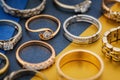 Background from various gold rings on colored paper Royalty Free Stock Photo