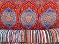 Background of various handmade cotton arabic fabrics. Chill out. Colorful wool Bedouin blankets. Arabic decoration and culture