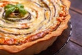 Background of Vegetable Spiral tart with zucchini, eggplant, carrot with a sprig of basil, close up macro shoot