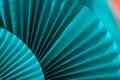 Background with vibrant large blue aqua paper oriental craft fans. Dark texture banner with deep shadows. Chinese New