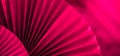 Background with vibrant large pink purple paper oriental craft fans. Dark texture banner with deep shadows. Chinese New