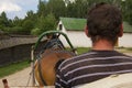 Background view man runs a rural cart with a horse, a museum of rural life