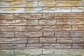 The background of the wall is made of artificial stone of elongated irregular shape in white, beige and gray colors. Backgrounds Royalty Free Stock Photo