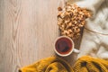 Background with warm sweaters and cup tea. Cozy still life in warm shades, space for text, Autumn winter concept. Royalty Free Stock Photo