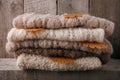 Background with warm sweaters. Pile of knitted brown clothes, warm background, knitwear, space for text, Autumn winter concept. Royalty Free Stock Photo