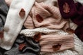 Background with warm sweaters. Pile of knitted clothes with autumn leaves, space for text, Autumn winter concept. Copy Space. Royalty Free Stock Photo