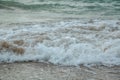 Background of waves beating on a sandy beach in stormy weather Royalty Free Stock Photo