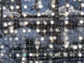 Bokeh on weld mesh. Melting snow glistening light effects background. Royalty Free Stock Photo