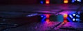 Background of wet asphalt with neon light. Blurred background, night lights of a big city, reflection, puddles.