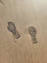 Footprints of human on wet sand. Beach sand seamless background.