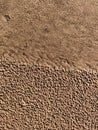 Background of wet sand with pores. Beach sand seamless pattern.