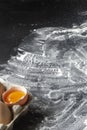 Background. White baking flour is dusted on the black table Royalty Free Stock Photo