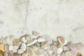 Background of white and bight semi-precious stones on marble background.