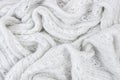 Background of white crumpled woolen fabric
