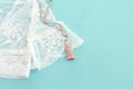 Background of white delicate lace fabric, dry flowers and necklace Royalty Free Stock Photo