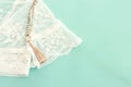 Background of white delicate lace fabric, dry flowers and necklace Royalty Free Stock Photo