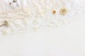 Background of white delicate lace fabric, dry flowers and pearls Royalty Free Stock Photo