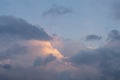 Background with white, gray and black coulds against blue sky at sunset time