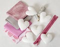 Background of white handmade textile hearts and sewing tools and accessories in pink. - image