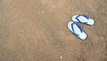 Background of white slippers or flip flops on beach. Royalty Free Stock Photo