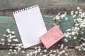 Background with white small flowers, blank notepad page and gift Royalty Free Stock Photo