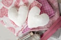 Background of white textile hearts and sewing tools and accessories in pink - image