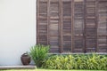 Background white wall with latticed wooden doors in the tropical house