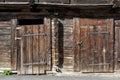 Background and wood texture from a wall of an old wooden house with doors and windows Royalty Free Stock Photo