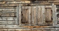 wall of an old wooden house with windows closed by shutters Royalty Free Stock Photo