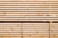 Background from wooden boards. Stacked stacks of wooden planks. Lumber warehouse, wood drying, building material.