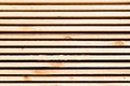 Background from wooden boards. Stacked stacks of wooden planks. Lumber warehouse, wood drying, building material.