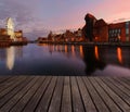 Background with wooden floors and Gdansk cityscape, after sunset