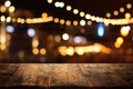 Background of wooden table in front of abstract blurred restaurant lights Royalty Free Stock Photo