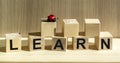 On the background of a wooden table, the text Learn on wooden blocks . Royalty Free Stock Photo