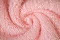 Background of woolen knitted pink warm sweater top view