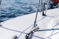 Background - yachting. fragment of the hull of a sailing vessel with rigging against the backdrop of water