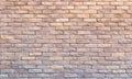 Background of yellow facing bricks. Bricks relief close up Royalty Free Stock Photo