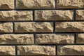 Background of yellow facing bricks. Close up. Royalty Free Stock Photo