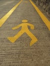 Background of yellow Pedestrian sign on the walk way. Close up of Pedestrian walking figure painted sign icon symbol in yellow Royalty Free Stock Photo