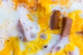 Background, yellow scrambled eggs with two slices of sausage, to