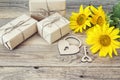 Background with yellow sunflowers, gift boxes, heart-lock and key on old wooden boards