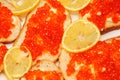 Backgrounf of bread and butter with red caviar and lemon Royalty Free Stock Photo