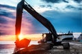 Backhoe or digger working with bucket at industrial earth excavation site